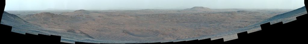 Mars Weather Network Tracks How Dust Shapes the Climate rover tracks across the dusty red surface of Mars