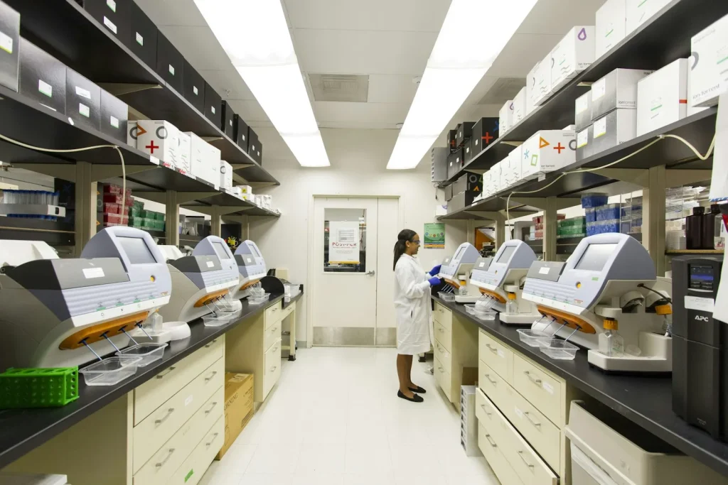 Laboratory scientist in protective clothing analysing samples in a public health laboratory